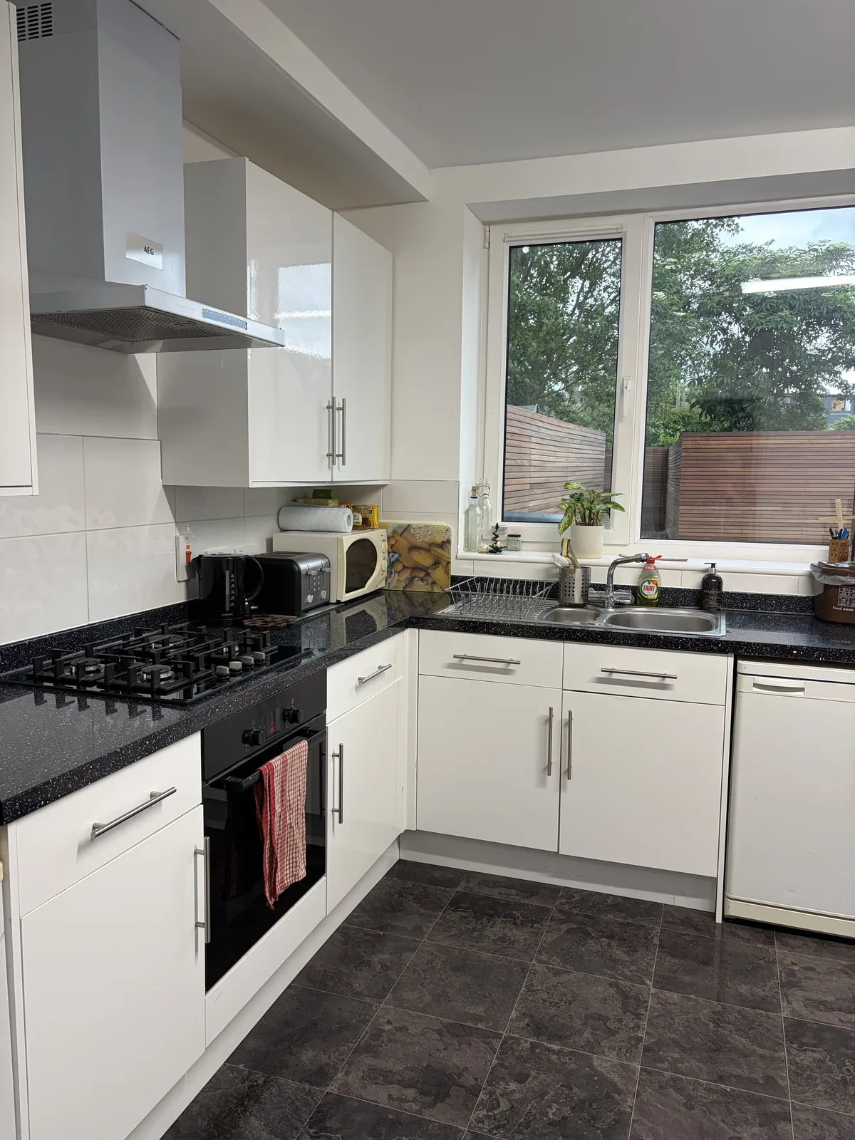 Same white kitchen after cleaning by HomeGlow Cleaning Services
